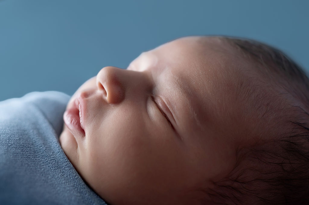 Details of the side of a sleeping newborn baby's face after visiting Basking Babies